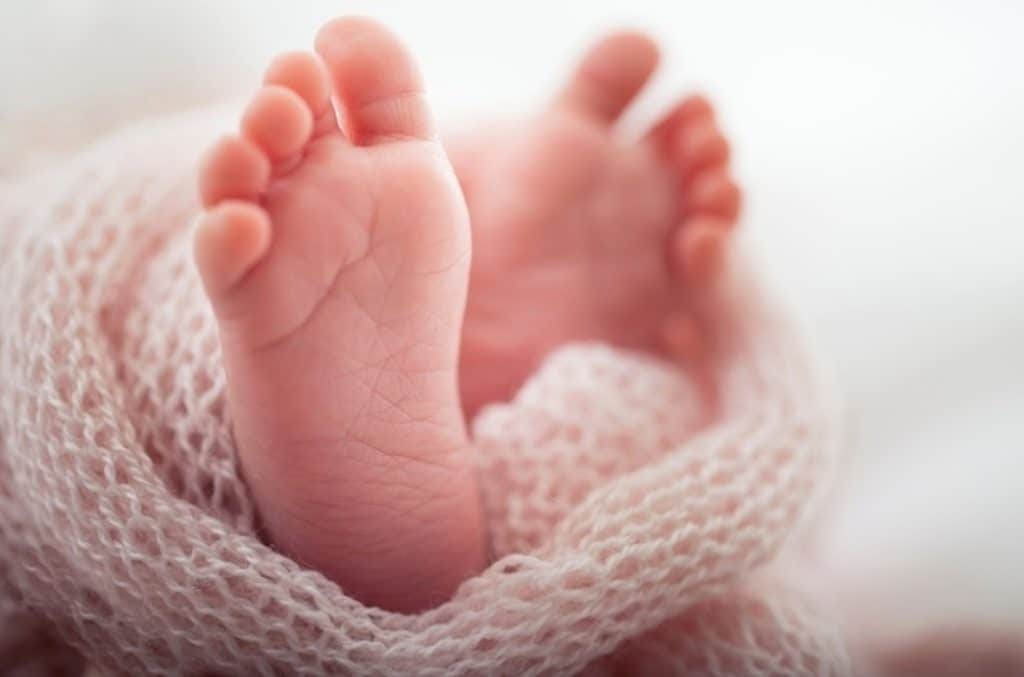 A newborn baby’s feet, representing multigenerational family financial planning and wealth stewardship.