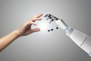 A human hand and a robotic hand reaching toward each other, symbolizing the contrast between personalized financial advice from a human advisor and AI-driven financial tools.